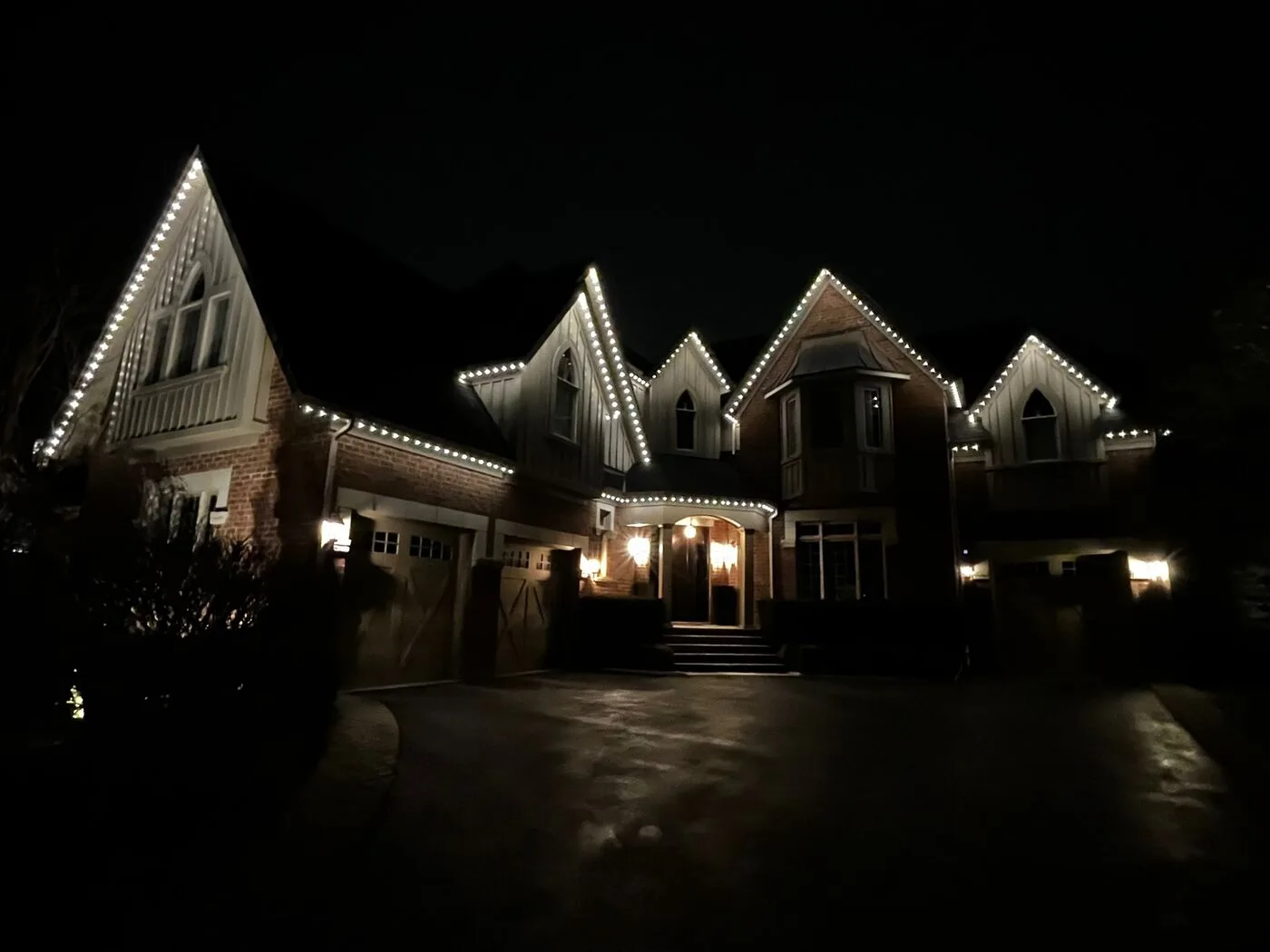 Home with permanent LED roofline lighting installation at night
