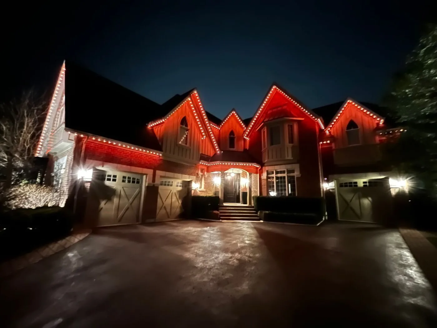 Vancouver home with red permanent LED roofline lighting at night