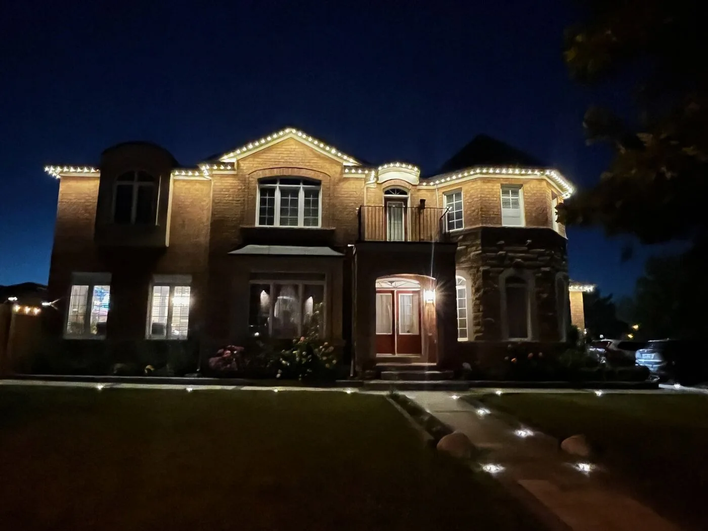 Home with warm white permanent LED soffit lighting at dusk