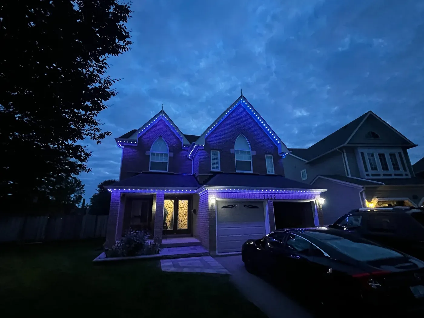 Modern Vancouver home with blue indigo LED soffit lighting at dusk