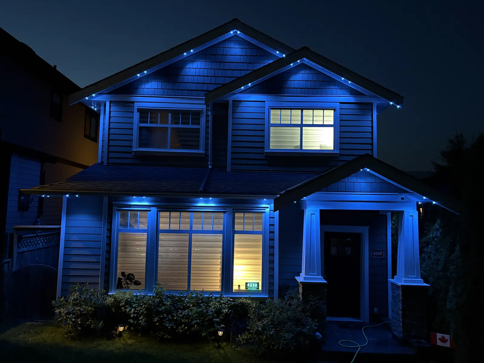 Vancouver home with bright blue permanent LED roofline and soffit lighting at night