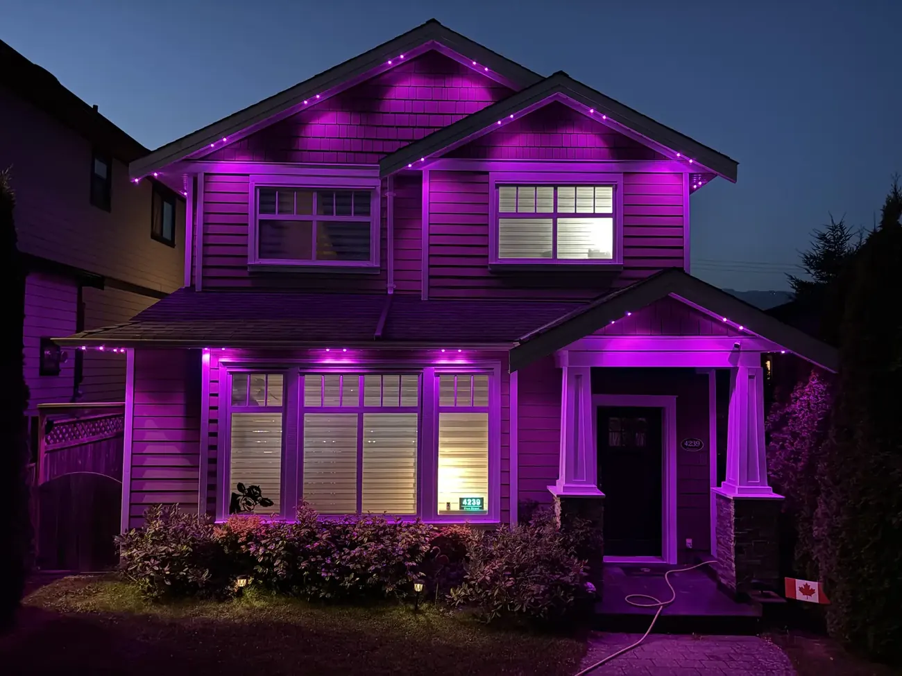 Vancouver home with pink and magenta permanent LED roofline and soffit lighting at night