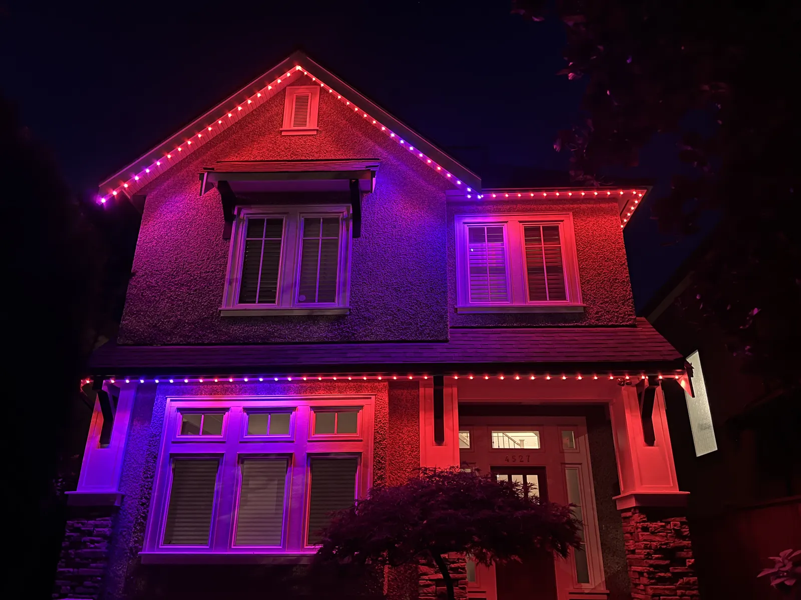 Vancouver home glowing with vivid red and magenta permanent LED roofline lighting