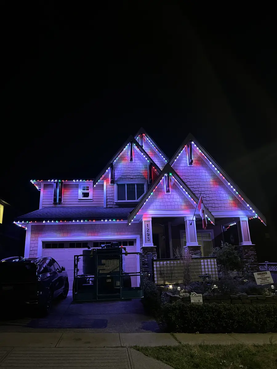 West Coast craftsman home with multicolor Christmas permanent LED roofline lighting installed by Vancouver Glow