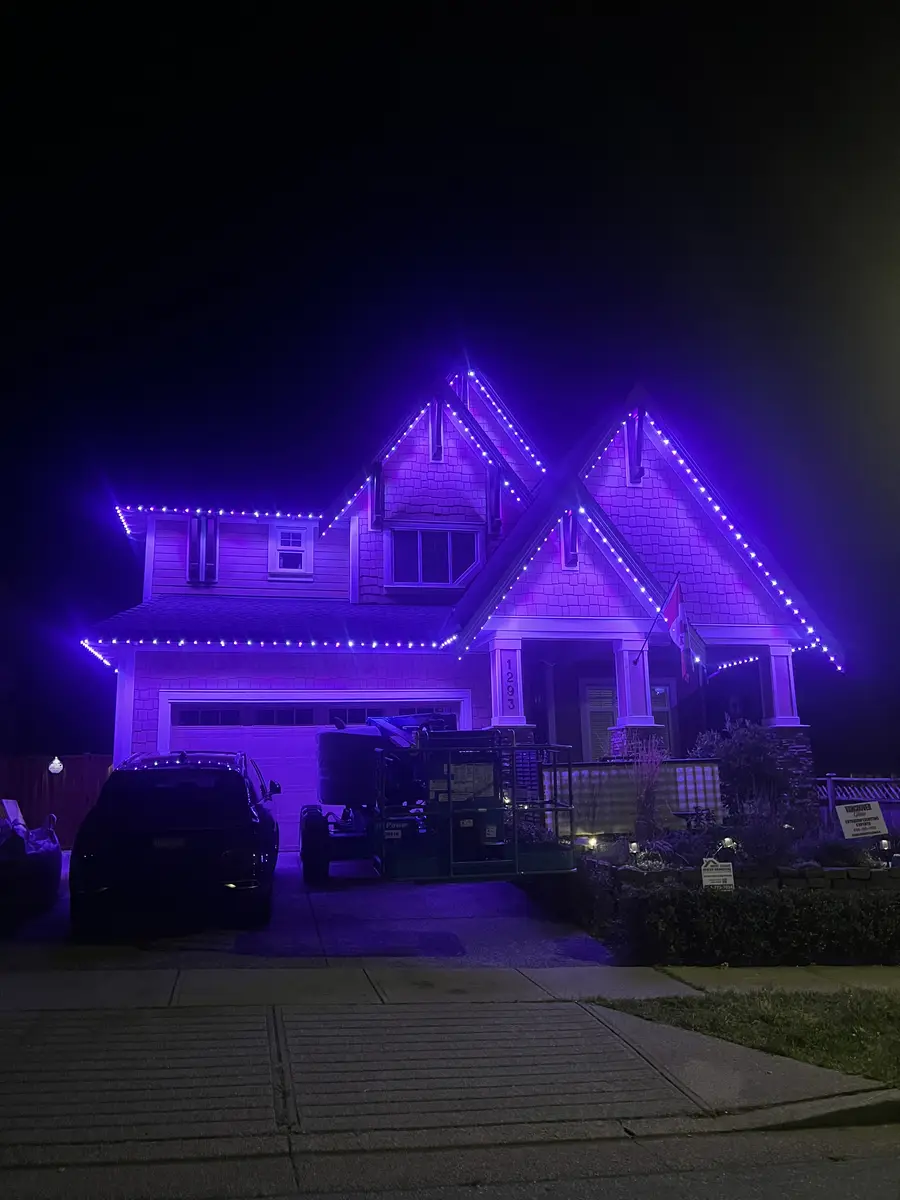 West Coast craftsman home with purple permanent LED roofline lighting installed by Vancouver Glow