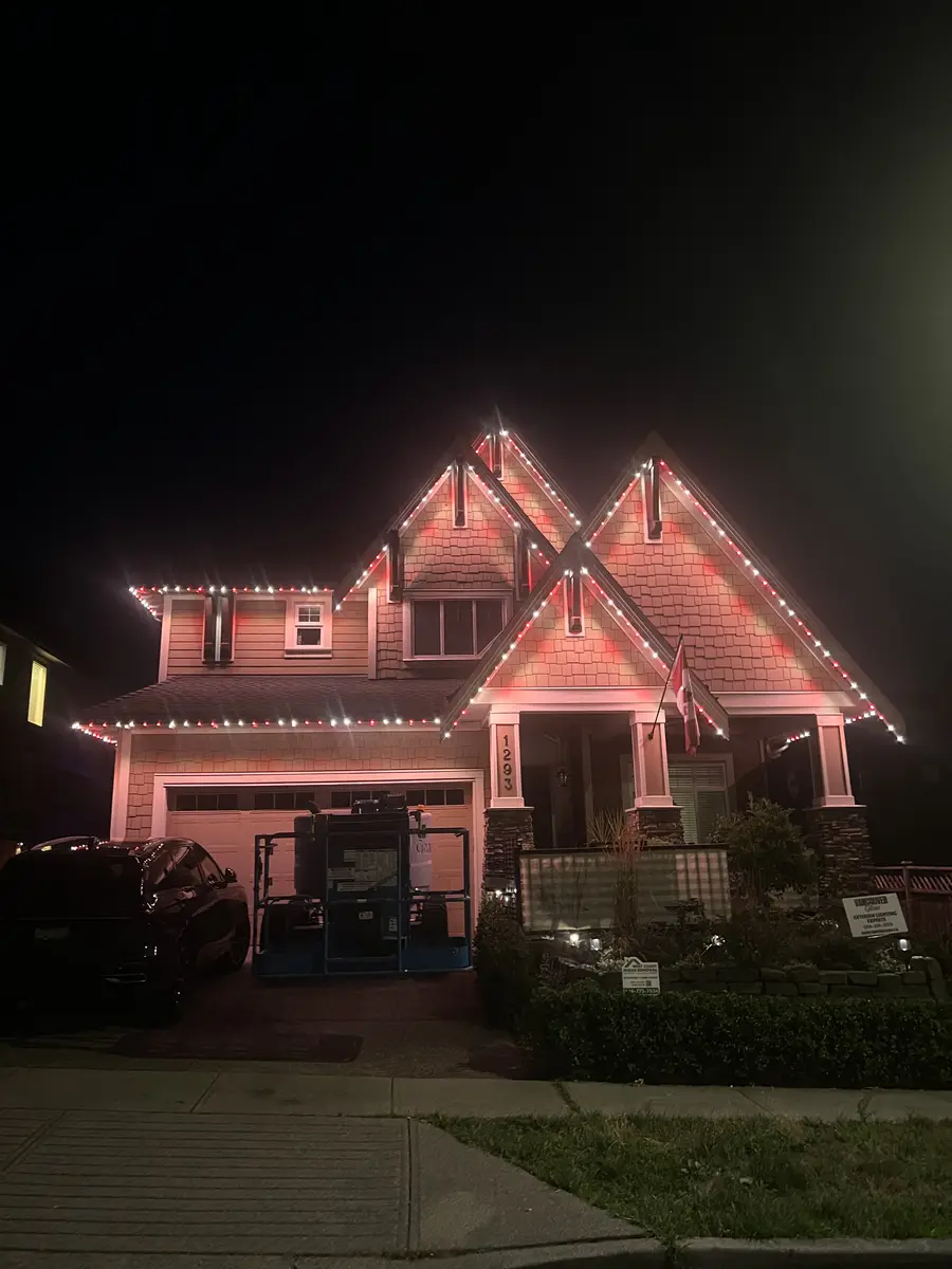West Coast craftsman home with red permanent LED roofline lighting installed by Vancouver Glow