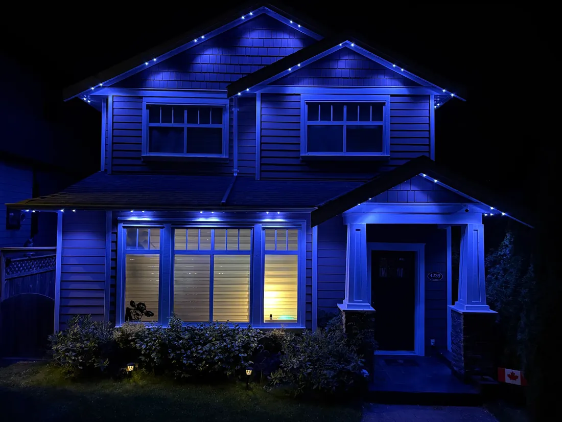 Vancouver craftsman home with royal blue permanent LED roofline lighting installed by Vancouver Glow