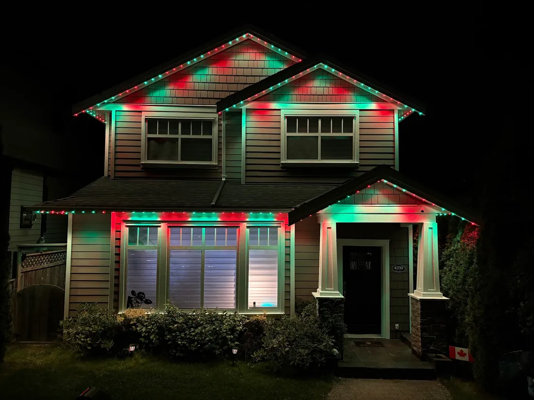 Vancouver craftsman home with red and green Christmas permanent LED roofline lighting installed by Vancouver Glow