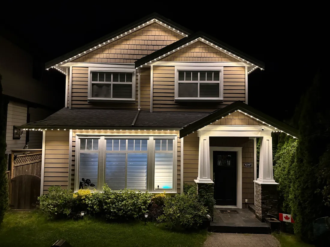 Vancouver craftsman home with warm white permanent LED roofline lighting installed by Vancouver Glow