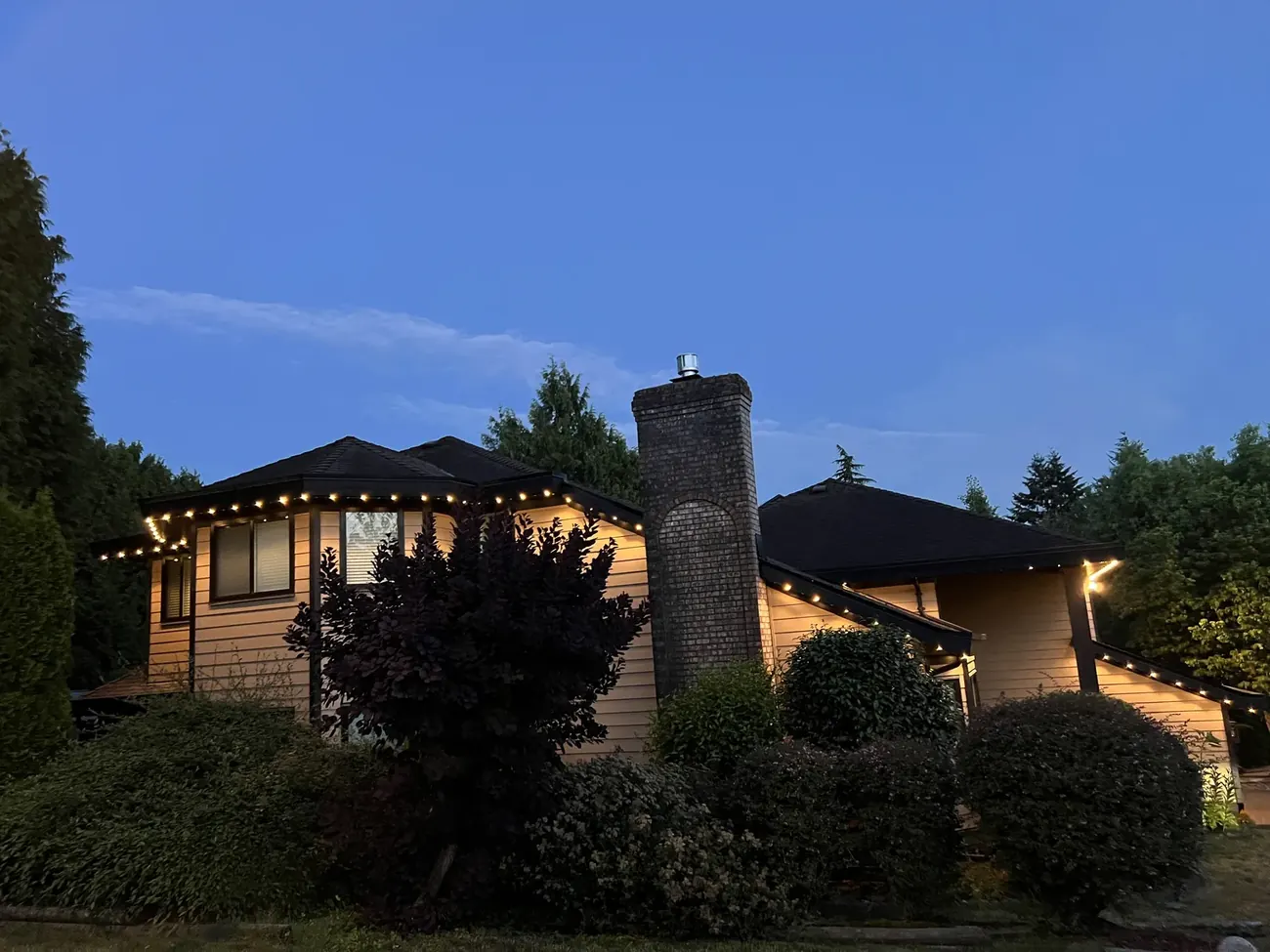 Vancouver home with warm white permanent LED lighting along roofline at dusk