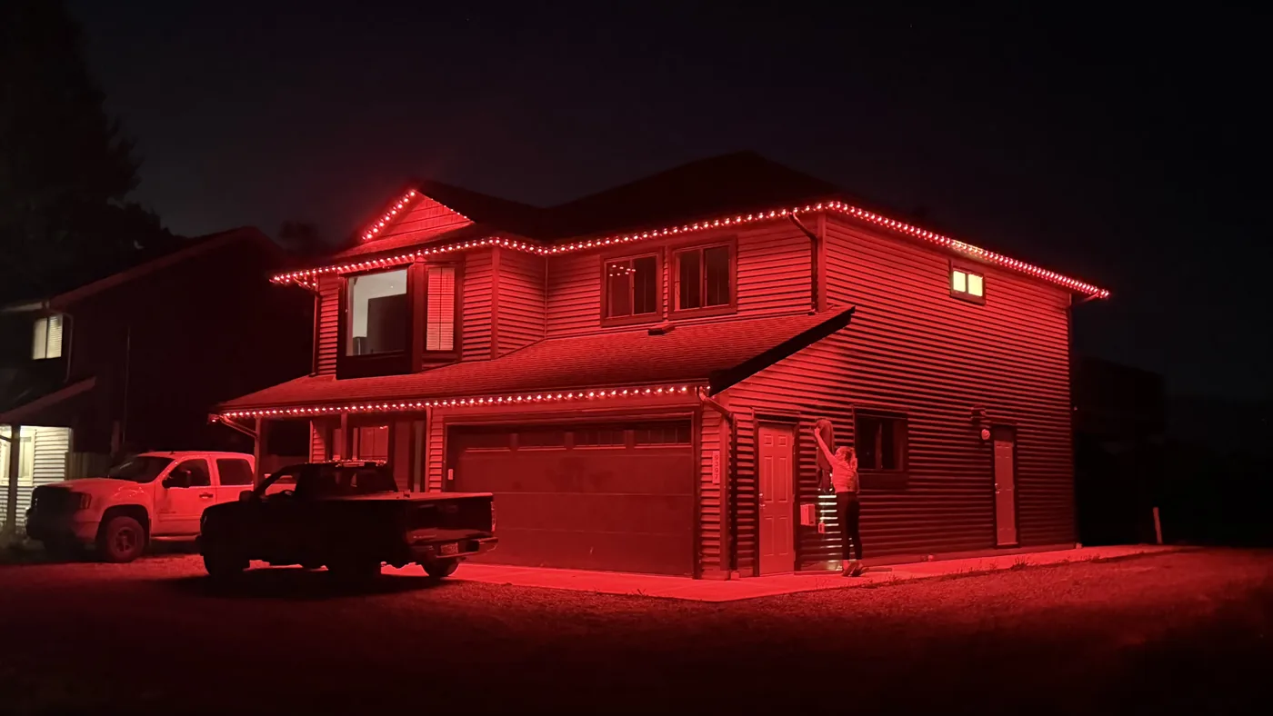 Greater Vancouver home with red permanent LED roofline lighting for Canada Day