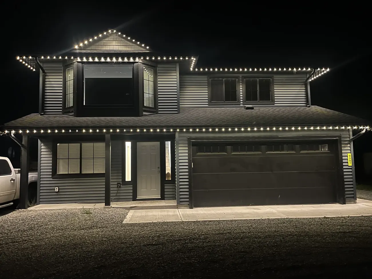 Modern Vancouver home with warm white permanent LED roofline and soffit lighting at night