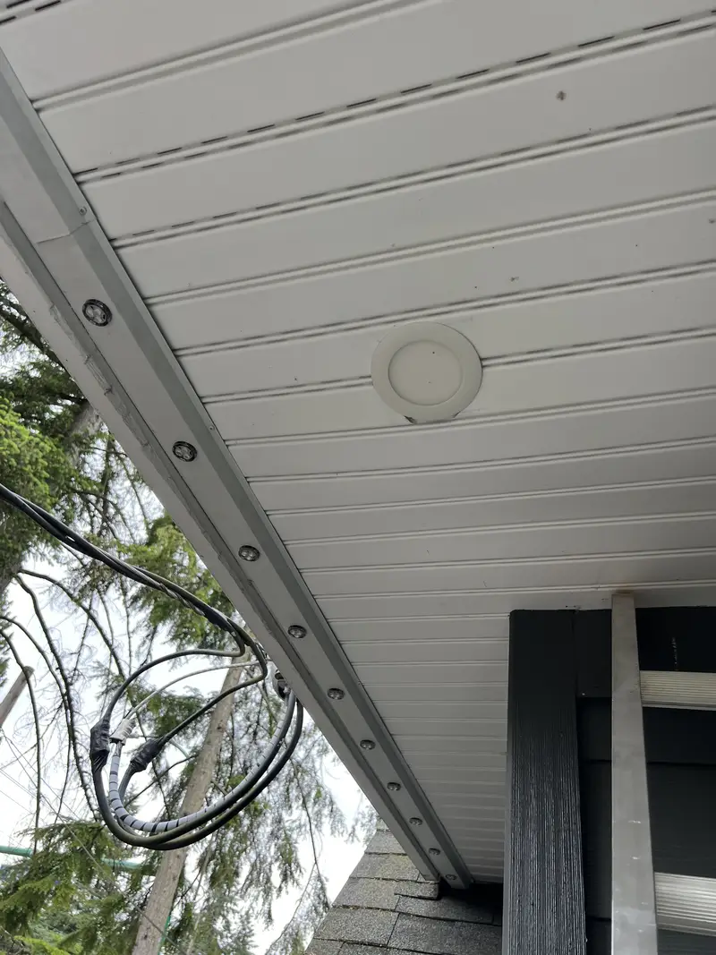 LED lights installed flush along white soffit with wiring routed neatly along the roofline