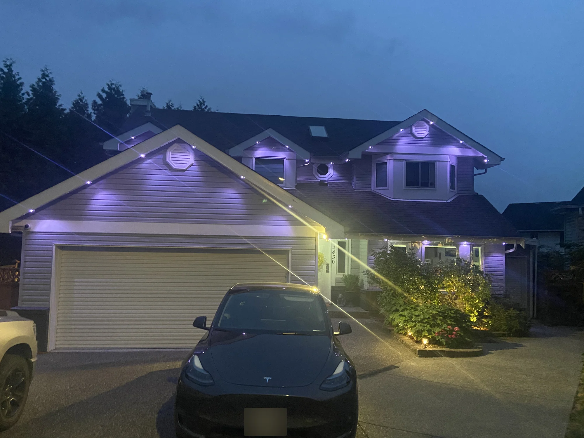 Vancouver home with warm white and soft purple permanent LED roofline lighting at dusk