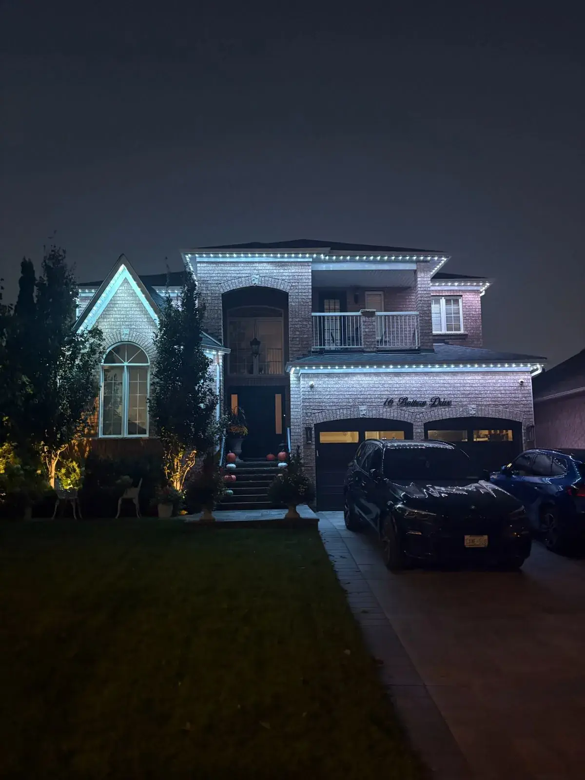 Vancouver home with cool white permanent LED roofline lighting at night